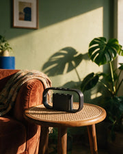 Arch Desk Holder – on a side table at golden hour