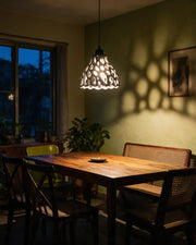 Cell Bell Pendant Light – at night on a bedside table
