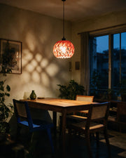 Cell Orb Pendant Light – at night on a bedside table