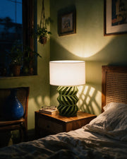 Chevron Lattice Table Lamp – at night on a bedside table