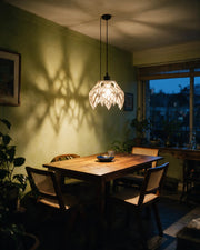 Claw Petal Pendant Light – at night on a bedside table