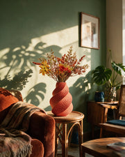 Coral Twist Vase – on a side table at golden hour