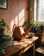 Facet Watering Can – on a work desk in morning sun