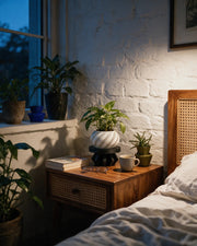 Faceted Plinth Plant Stand – at night on a bedside table
