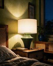 Fin Hourglass Table Lamp – at night on a bedside table