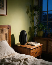 Fin Oval Vase – at night on a bedside table