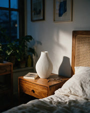 Fine Rib Teardrop Vase – at night on a bedside table