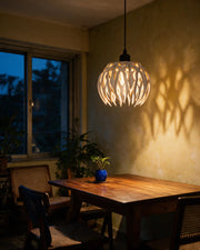 Flame Blade Pendant Light – at night on a bedside table