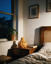 Flame Bud Vase – at night on a bedside table