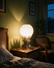 Flame Globe Table Lamp – at night on a bedside table