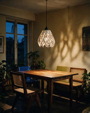 Flame Petal Pendant Light – at night on a bedside table