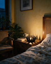 Flame Tealight Holder – at night on a bedside table
