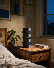 Gear Disc Vase – at night on a bedside table