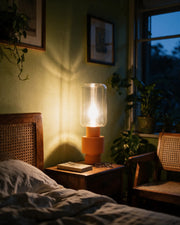 Glass Tube Table Lamp – at night on a bedside table