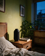 Knurl Bottle Vase – at night on a bedside table