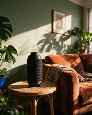 Knurl Bottle Vase – on a side table at golden hour