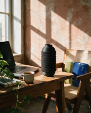Knurl Bottle Vase – on a work desk in morning sun