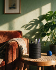 Knurl Pen Cup – on a side table at golden hour