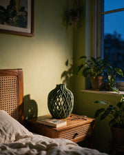 Lattice Bottle Vase – at night on a bedside table