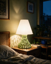 Lattice Cone Table Lamp – at night on a bedside table