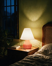 Mesh Bulb Table Lamp – at night on a bedside table