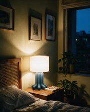 Organic Leg Table Lamp – at night on a bedside table