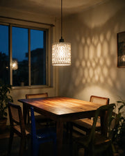Oval Perf Pendant Light – at night on a bedside table