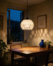 Petal Flame Pendant Light – at night on a bedside table