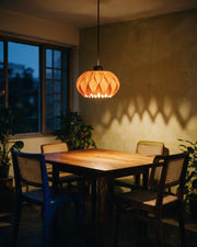 Petal Fold Pendant Light – at night on a bedside table