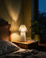 Pleat Cone Mini Lamp – at night on a bedside table