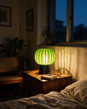 Pumpkin Shade Mini Lamp – at night on a bedside table