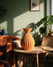 Radial Pleat Vase – on a side table at golden hour