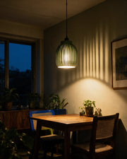 Rib Capsule Pendant Light – at night on a bedside table