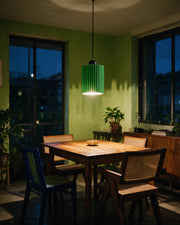 Rib Tube Pendant Light – at night on a bedside table