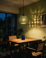 Spike Orb Pendant Light – at night on a bedside table