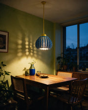 Spike Scale Pendant Light – at night on a bedside table