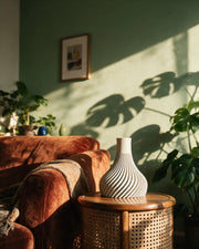 Spiral Fin Vase – on a side table at golden hour