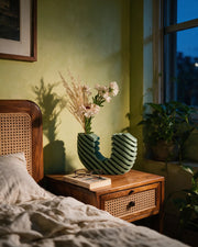 Step Wave Vase – at night on a bedside table