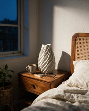Swirl Twist Vase – at night on a bedside table