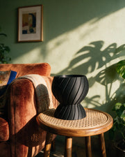 Twist Waist Planter – on a side table at golden hour