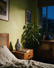 Wave Facet Vase – at night on a bedside table