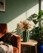 Wave Fin Vase – on a side table at golden hour