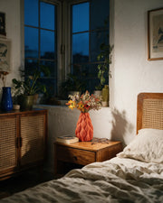 Wave Flow Vase – at night on a bedside table