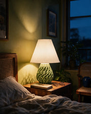 Web Base Table Lamp – at night on a bedside table