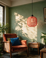 Web Capsule Pendant Light – on a side table at golden hour