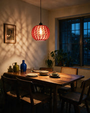 Woven Orb Pendant Light – at night on a bedside table