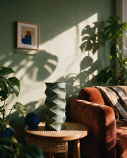 Zigzag Column Vase – on a side table at golden hour